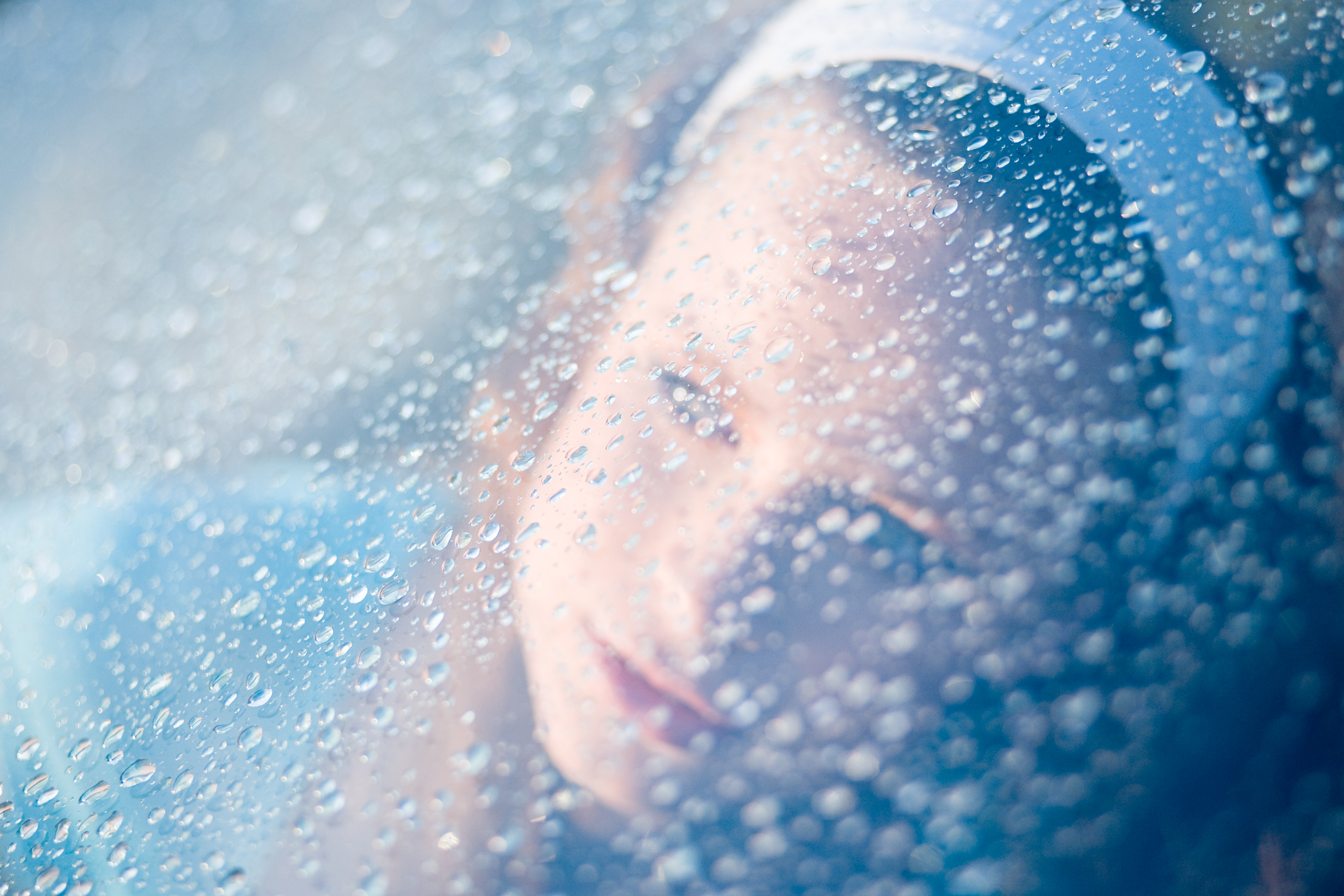 Woman portrait through drops